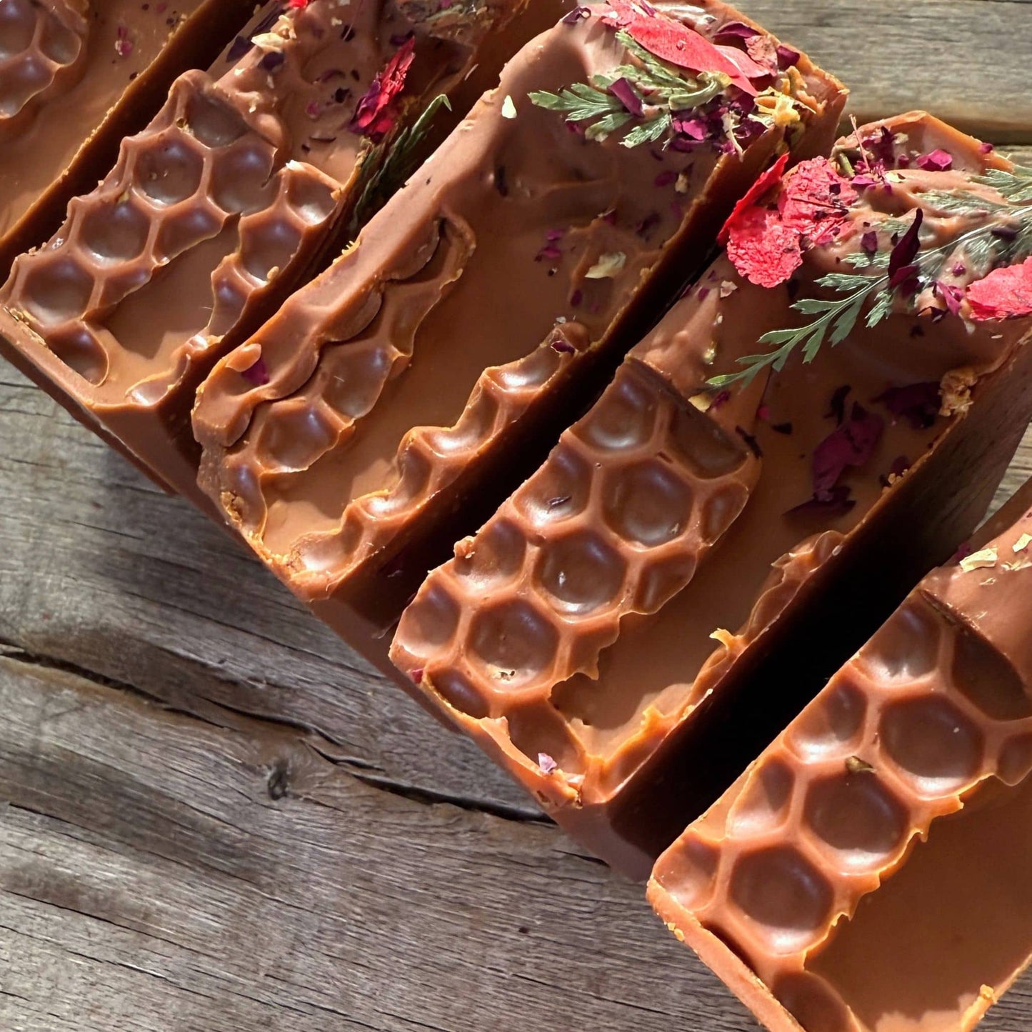 Close-up of Casablanca Curing Clay showcasing organic tallow for skin with vibrant pressed flowers.