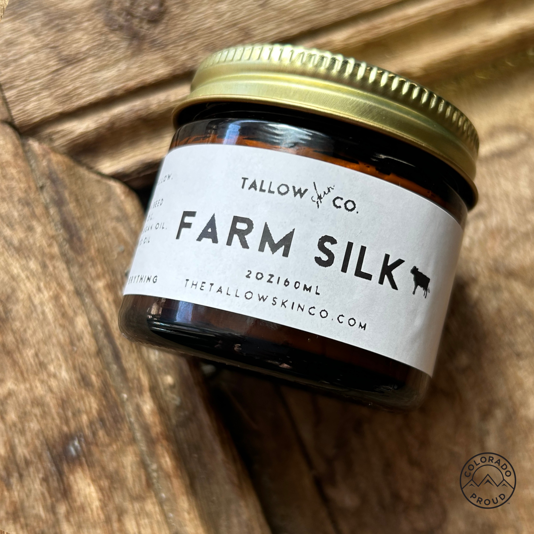 A glass amber jar of Farm Silk, an unscented tallow moisturizer.