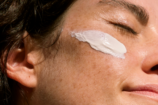 Grass-fed tallow moisturizer on women's cheek 