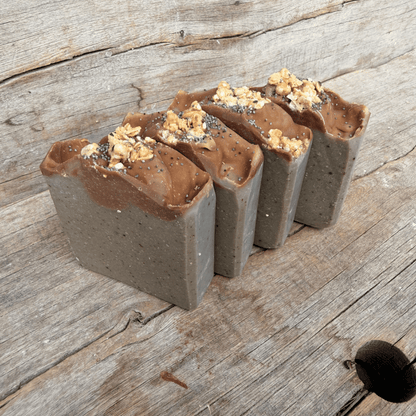Angled view of handmade Blueberry Muffin tallow soap with a muted blueberry base and textured oat granola topping.