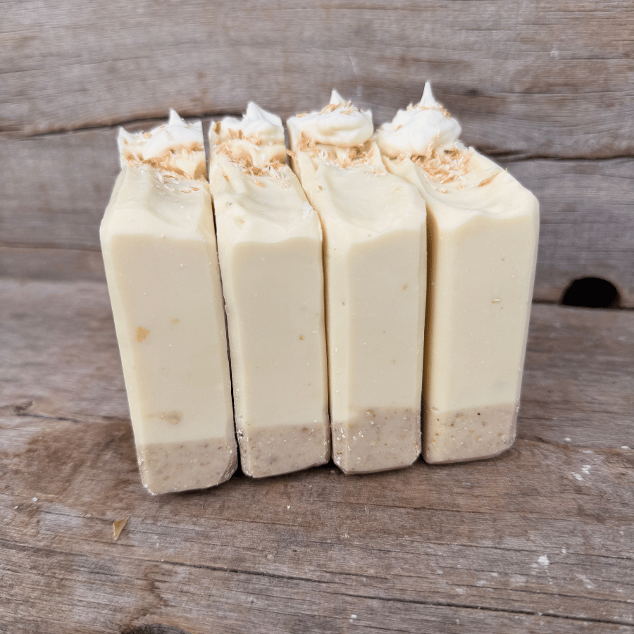 Coconut Cream Pie tallow soap bars with an exfoliating oat and cocoa crust, creamy coconut layer, and piped topping.