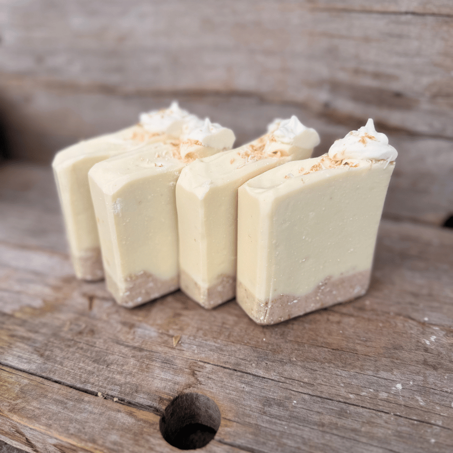 Small-batch Coconut Cream Pie tallow soap bars with toasted coconut, colloidal oats, and a textured exfoliating crust.