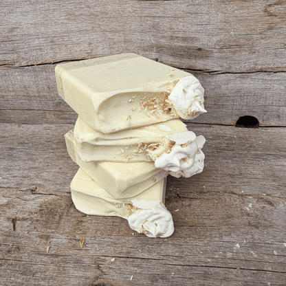 Stacked Coconut Cream Pie tallow soap bars showing the layered oat crust, creamy coconut soap, and toasted coconut topping.