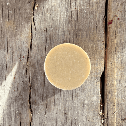Close up of a rich cocoa and shea butter solid conditioning bar