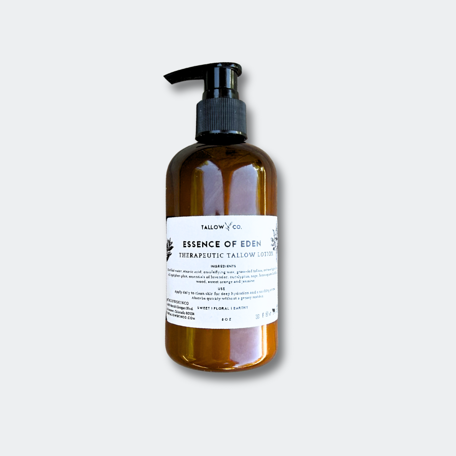 Essence of Eden Tallow Body Lotion glass bottle on a minimalist background