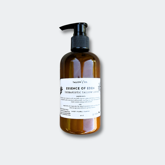 Essence of Eden Tallow Body Lotion glass bottle on a minimalist background