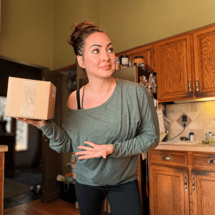 Tallow Skin Co. founder holding a mystery skincare gift box, featuring a thoughtfully curated surprise assortment of handcrafted skincare, bath, and body care favorites.