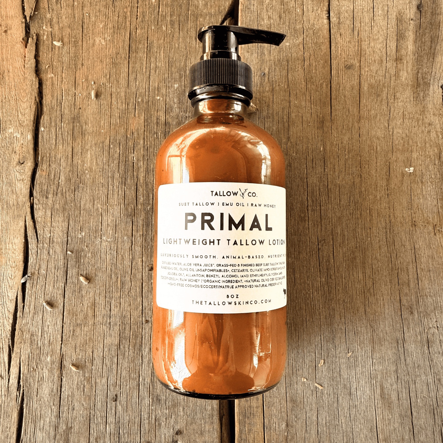Bottle of Tallow & Co Primal Lightweight Tallow Lotion on a wooden surface