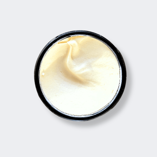 Jar of tallow cream on a light gray background