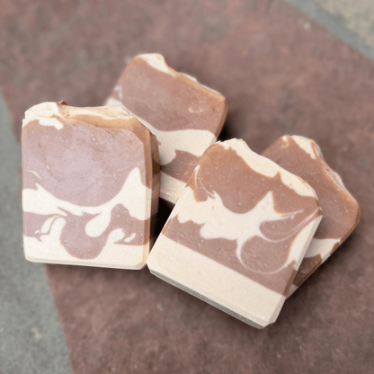 Four Almond Cookie tallow soap bars arranged together, displaying individually swirled cocoa and cream patterns.