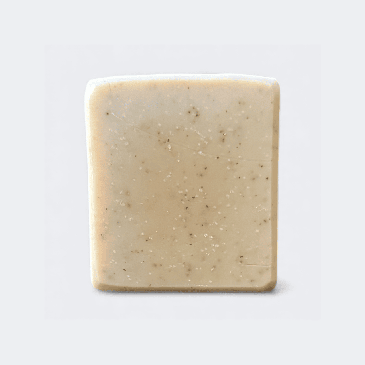 Handmade Black Tea and Basil Tallow Soap bar on a rustic wooden surface