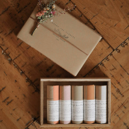 Artisan earth pigment makeup sticks next to a small dried flower bouquet