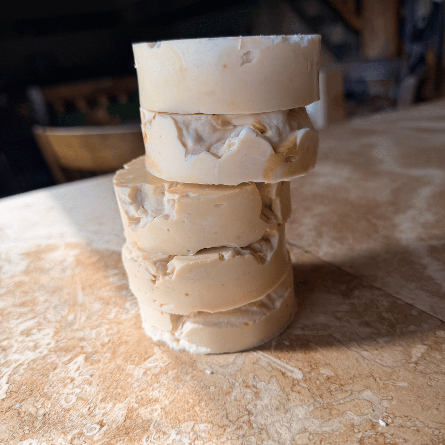 Stack of five rustic, cream-colored handmade tallow soap rounds with uneven edges and textured surfaces, part of Tallow Skin Co.'s discounted Messies collection.